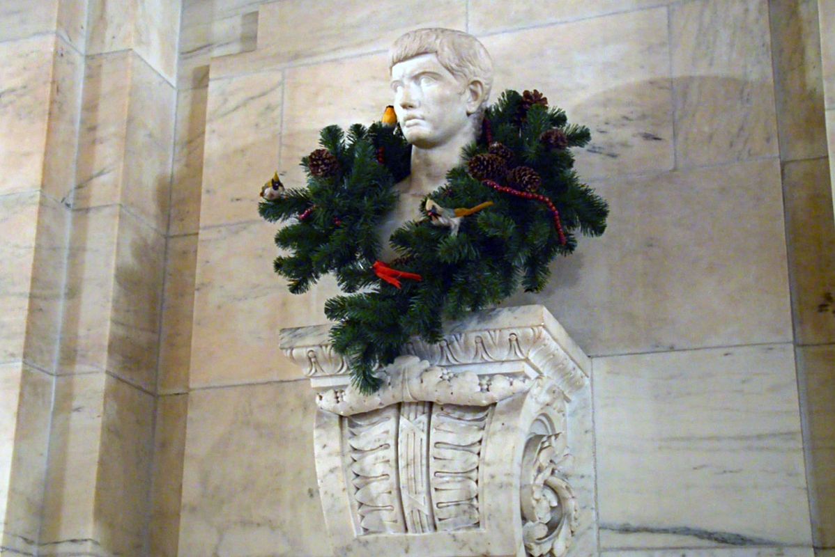 11-3 Statue Of A Head With A Christmas Garland In The Hallway Behind The Entrance Lobby Astor Hall New York City Public Library Main Branch